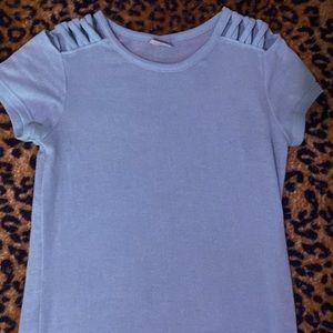 It’s a light blue shirt with cutouts at the sholder